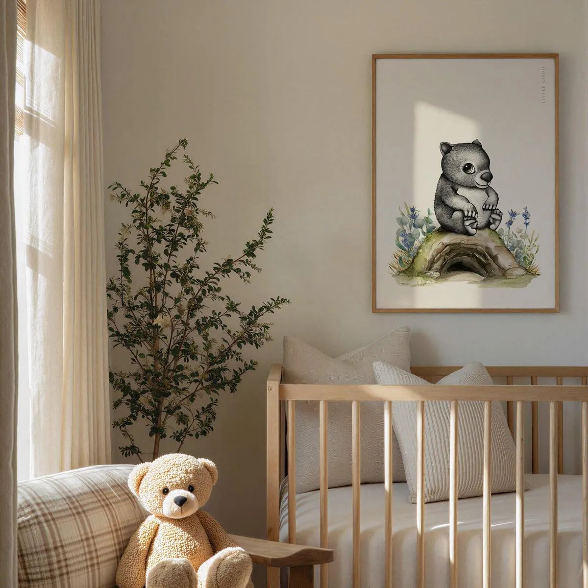 Whimsical wombat nursery wall art hanging above a wooden baby crib, gender-neutral Australian animal decor in a bright, modern nursery.