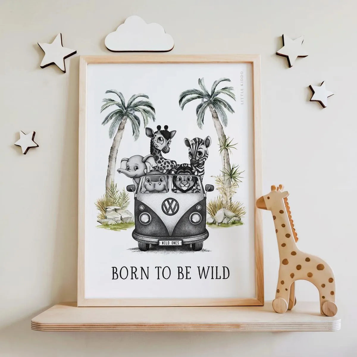 "Born to Be Wild" safari animal print leaning on a wooden shelf next to a wooden giraffe toy and star wall decor.