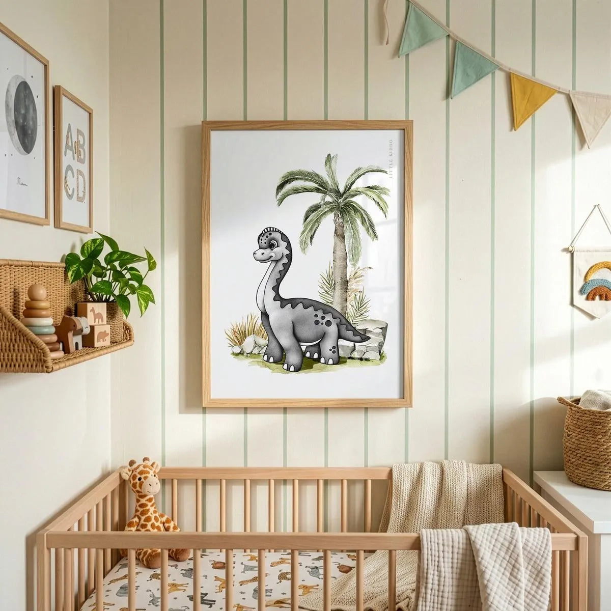 Minimalist baby Brachiosaurus art hanging above a wooden crib in a nursery with striped wallpaper and colorful bunting.