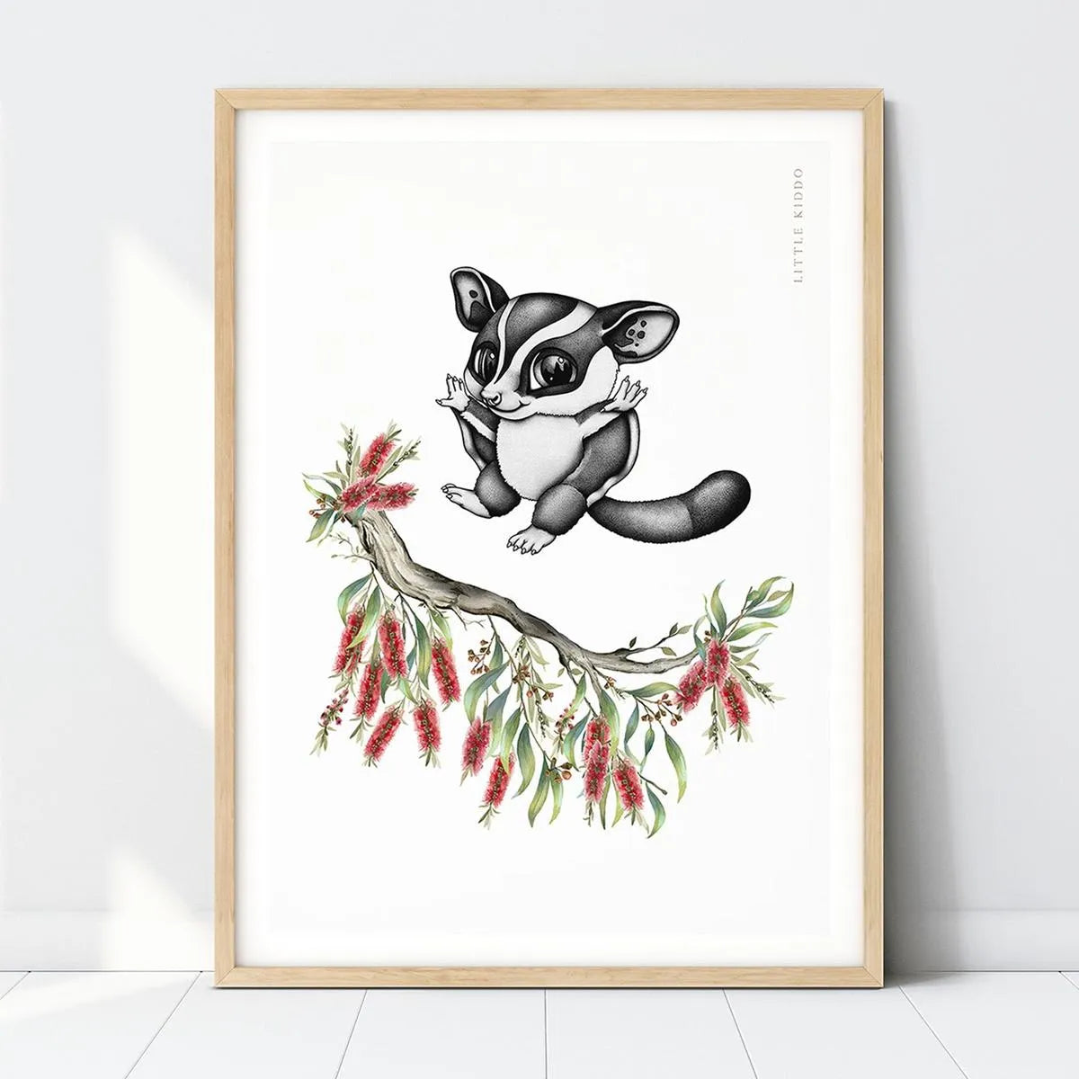 Hand-drawn sugar glider nursery art print perched on a red Bottlebrush branch in a light wood frame, Australian animal wall decor.