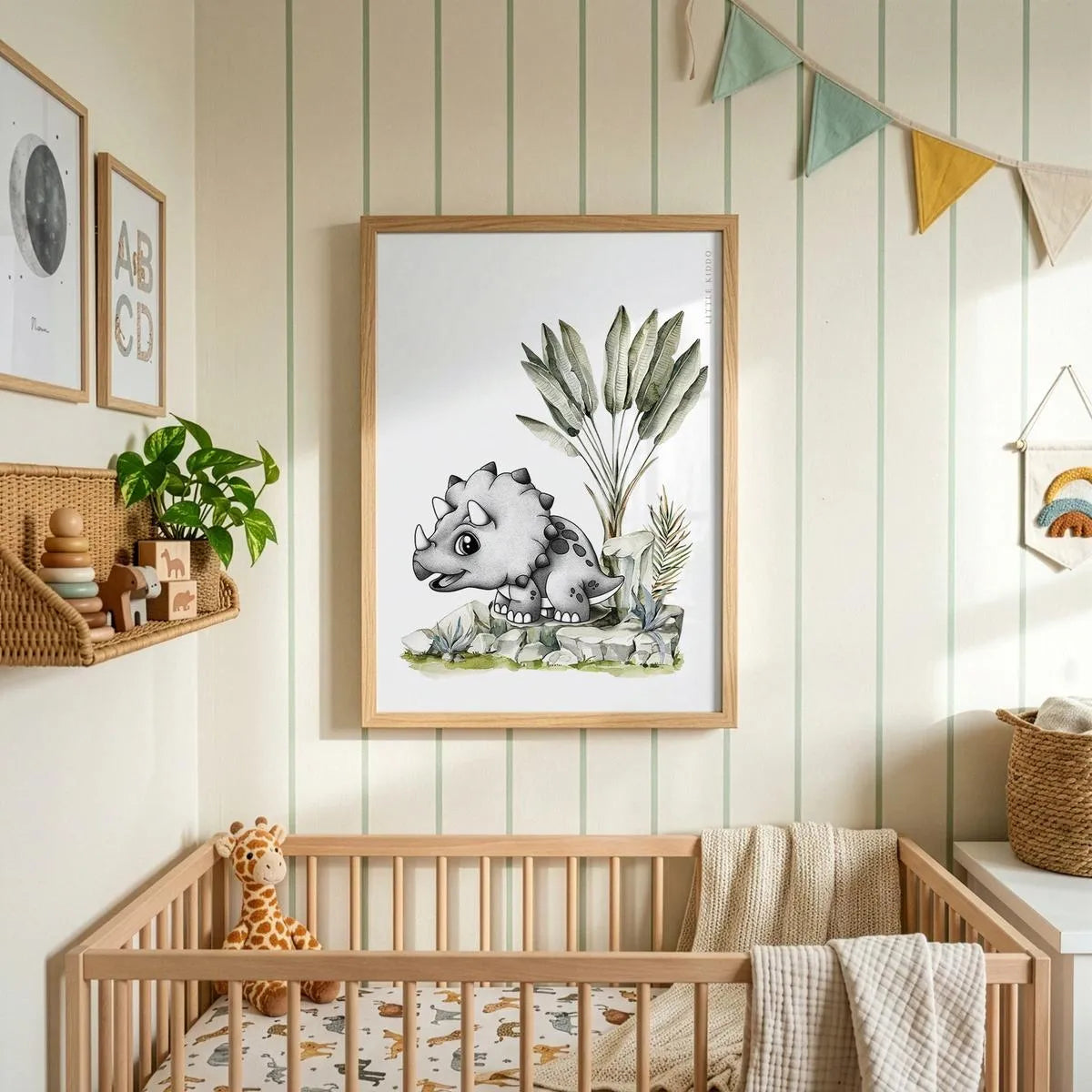 Whimsical baby Triceratops art hanging above a wooden crib in a nursery with striped wallpaper and colorful bunting.
