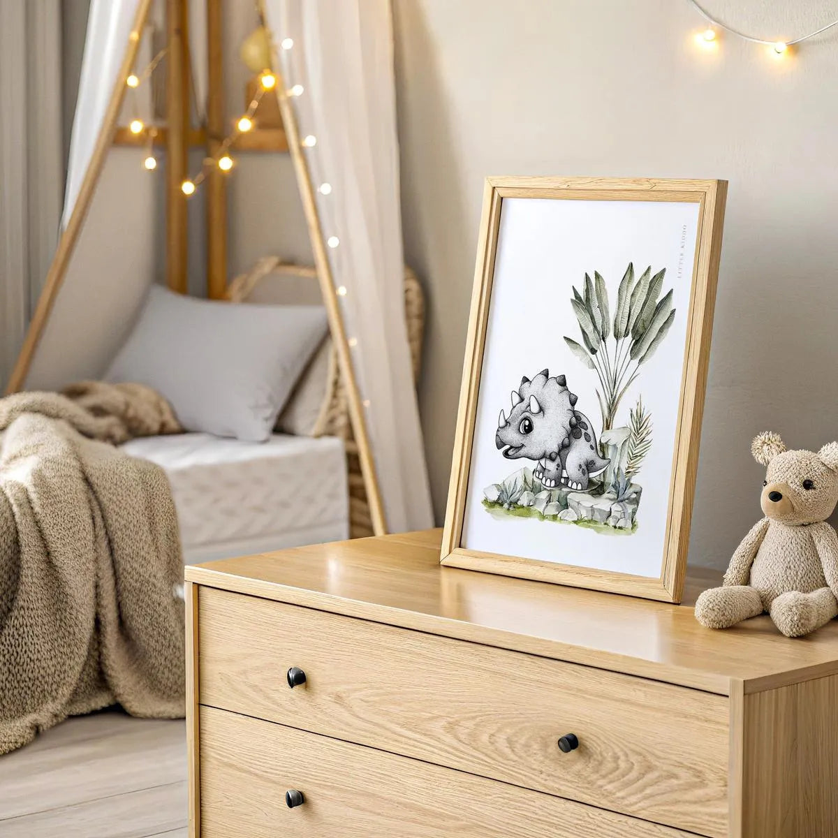 Sophisticated triceratops nursery wall art featuring hand-drawn stippling and soft watercolor leaves, displayed in a modern, neutral kids bedroom.