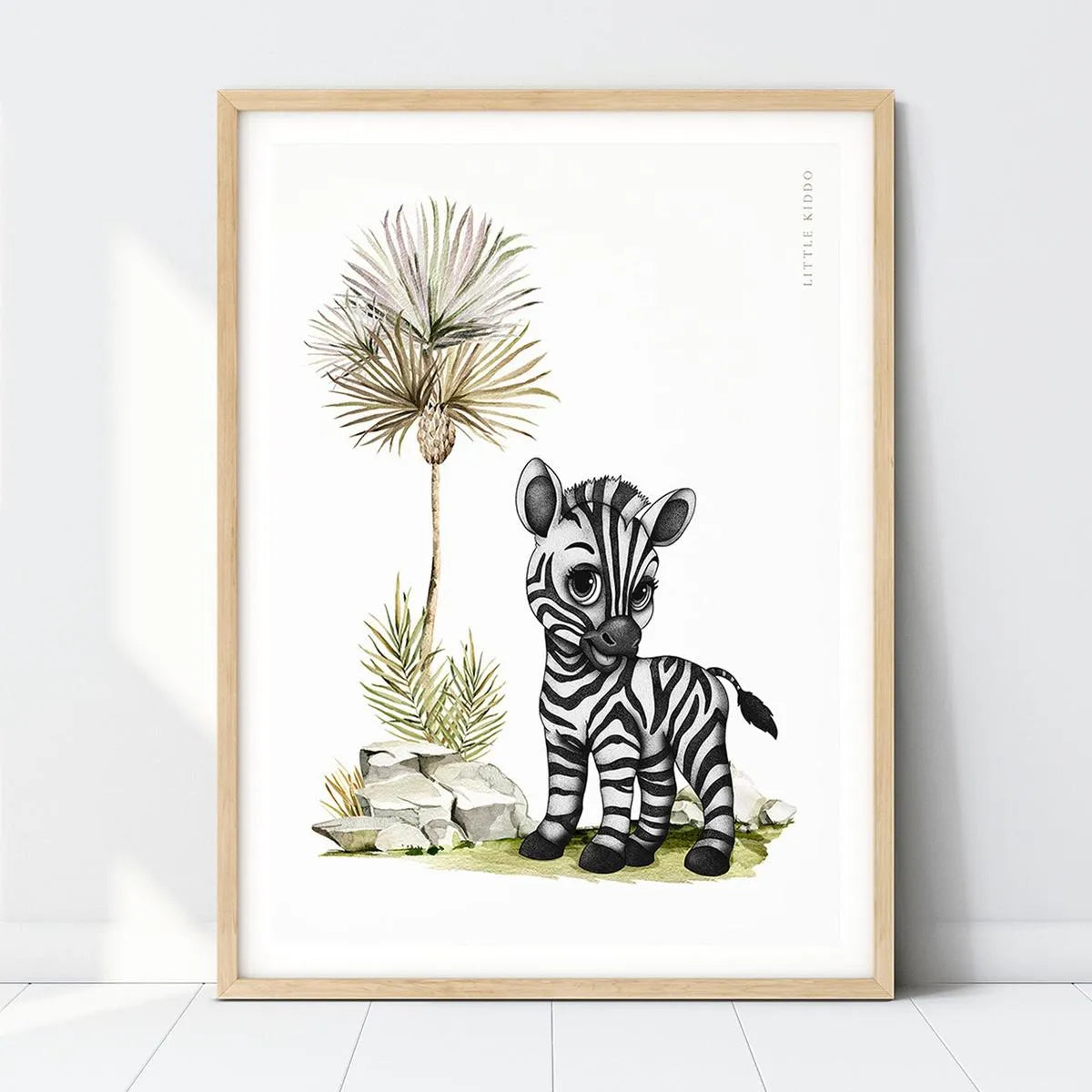 PJ the Zebra nursery art print featuring a hand-drawn baby zebra and palm tree in a light wood frame for a safari-themed room.