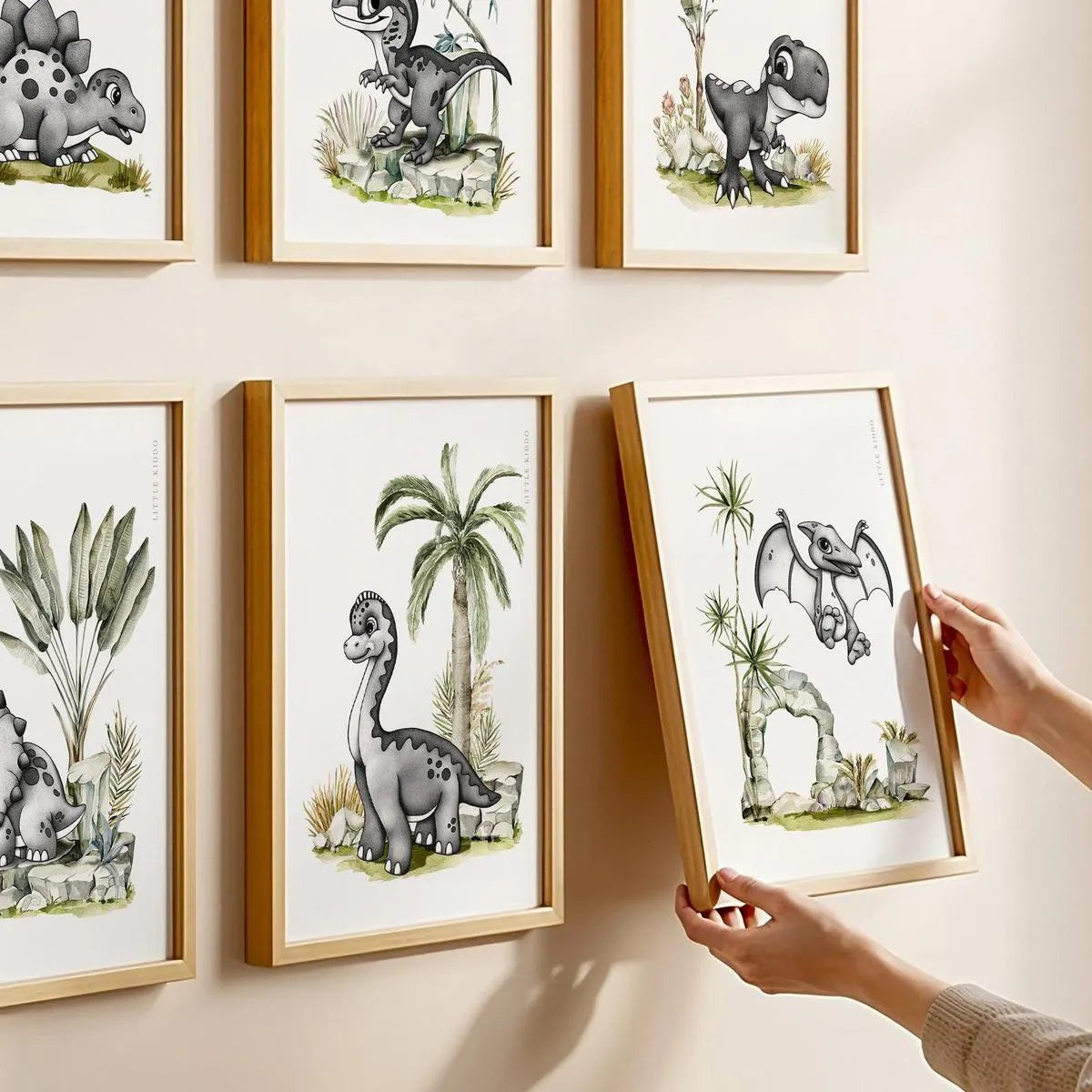 Minimalist dinosaur themed nursery gallery wall featuring hand-inked animal prints in oak frames.