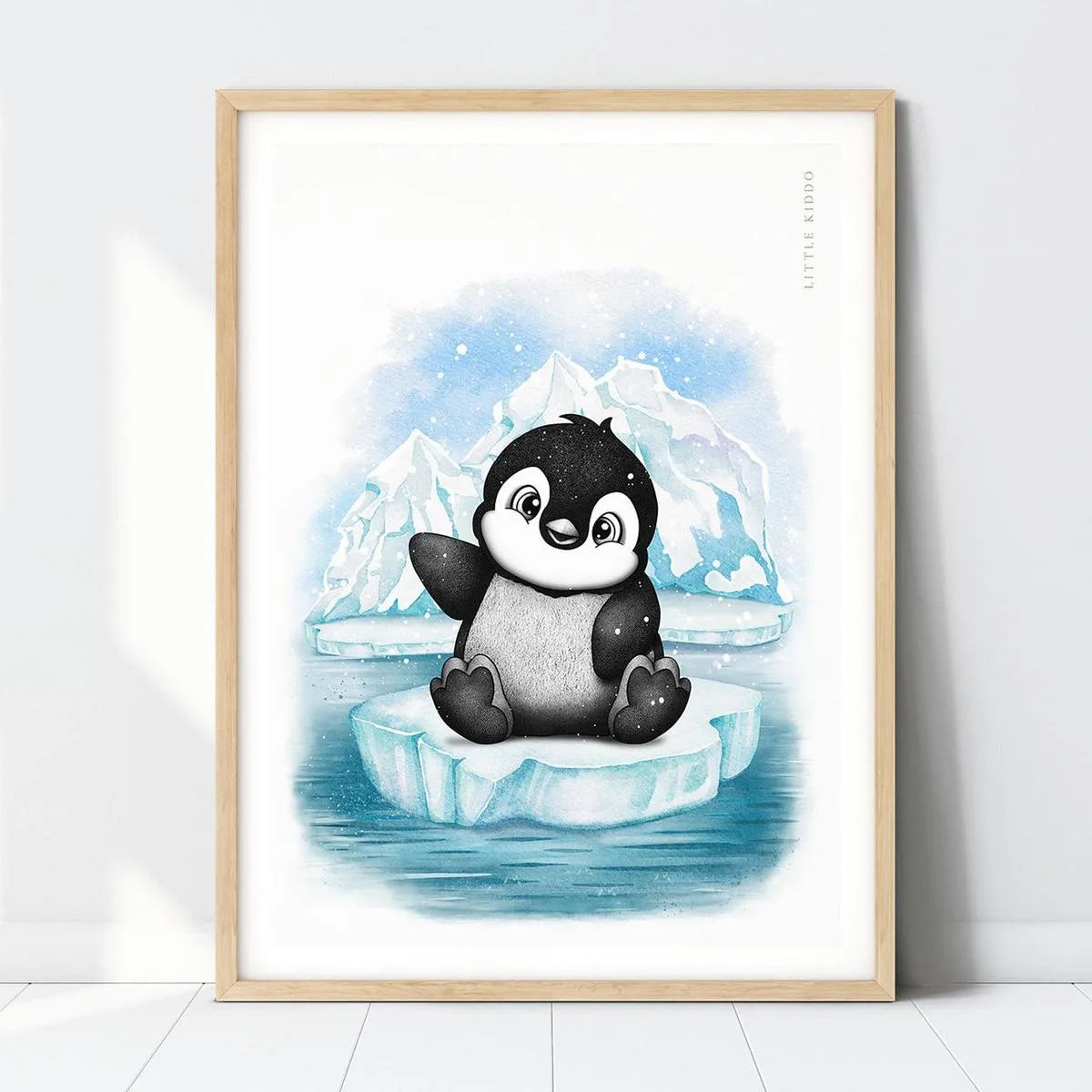 Hand-drawn baby penguin nursery art print in a light wood frame, cute Antarctic animal illustration for kids room.