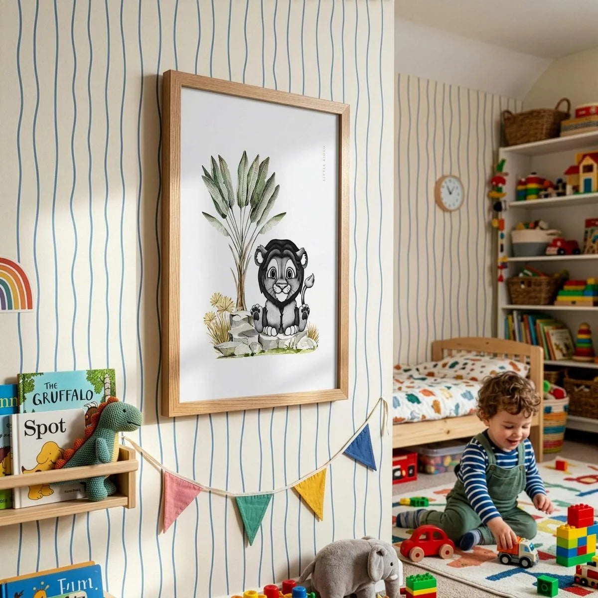 Framed lion cub adventure poster for kids, styled in a bright playroom with striped wallpaper, colorful bunting, and a toddler.