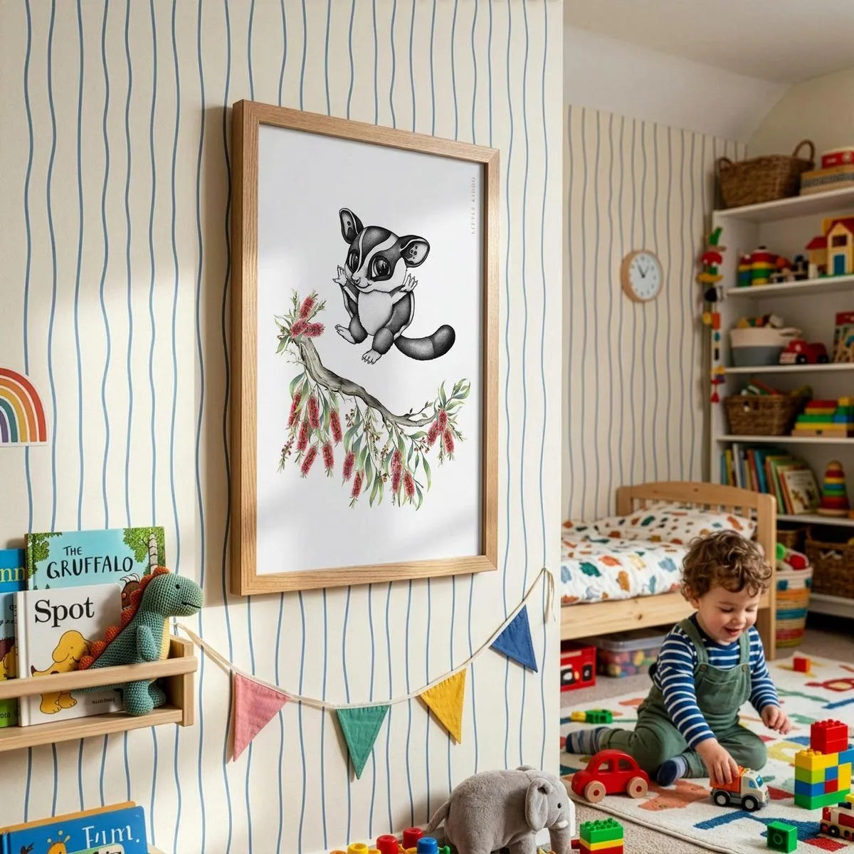 Framed sugar glider adventure poster for kids, styled in a bright playroom with striped wallpaper, colorful bunting, and a toddler.