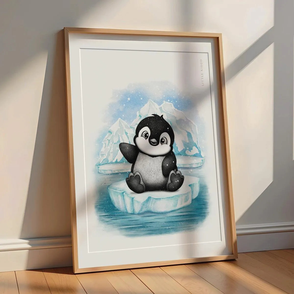 Minimalist penguin nursery print leaning against a white wall with soft sunlight, gender neutral winter animal wall art.