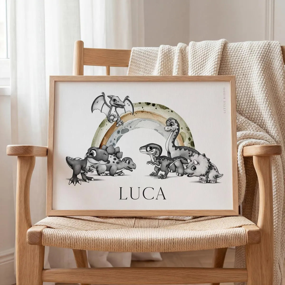 Custom "Luca" dinosaur rainbow art print displayed on a wicker chair, unique personalized baby shower gift for a safari or jurassic themed nursery.