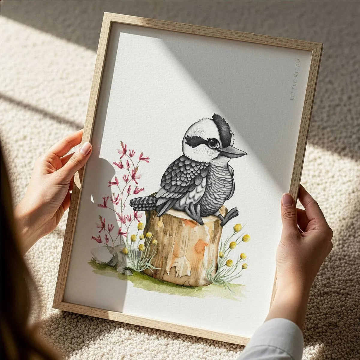 Close-up of a hand-inked Kookaburra illustration for a kids' room, featuring detailed stippling and soft watercolor native Australian florals.